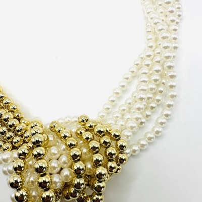 Colar de pérolas brancas e contas douradas entrelaçadas