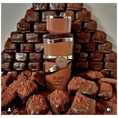 Frasco de perfume ou creme bronze com inscrição JUST CHOCO rodeado por pedaços de chocolate