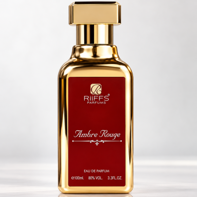 Frasco dourado de perfume com rótulo vermelho Ambre Rouge