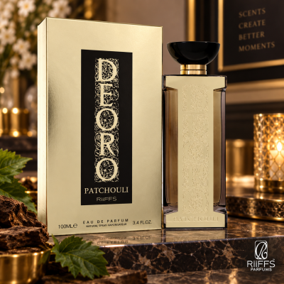 Frasco e caixa dourada de perfume DFORO PATCHOULI sobre mármore iluminado