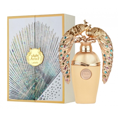 Frasco de perfume dourado com decoração de penas de pavão e caixa com imagem de penas