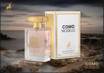 Frasco e caixa de perfume COMO MOISELLE sobre superfície rochosa