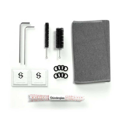 Conjunto de manutenção para cachimbo com múltiplos acessórios dispostos sobre superfície branca.