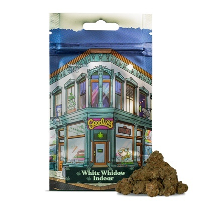 Pacote colorido com desenho de edifício e buds de cannabis verdes castanhos ao lado