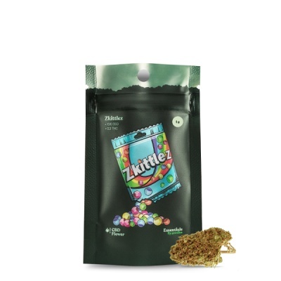 Embalagem preta com desenho colorido e flor seca de cannabis ao lado