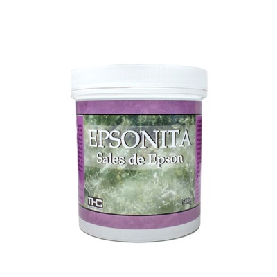 Recipiente branco com sales de Epson EPSONITA com rótulo roxo e imagem de cristais verdes.
