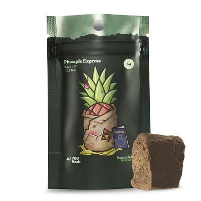 Embalagem preta e verde com ananás ilustrado e bloco castanho ao lado