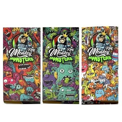 Três caixas coloridas com desenhos de monstros e logo King Monkey Monsters