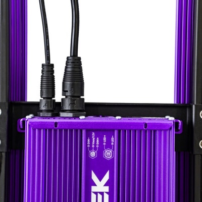 Carregador metálico roxo com cabos pretos conectado e texto branco EK