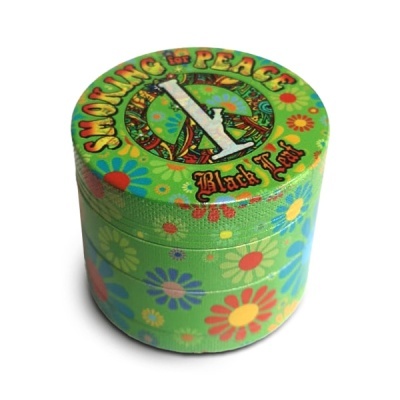 Mini caixa de metal verde com padrão floral colorido e texto no topo