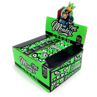 Embalagem verde King Monkey com caixas de papel de filtros decoradas com rostos expressivos.