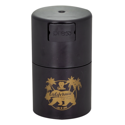 Frasco preto cilíndrico com botão 'press' e design dourado com palmeiras e urso