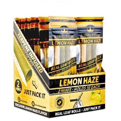 Caixa amarela com embalagens de King Palm Lemon Haze contendo rolls de folha real