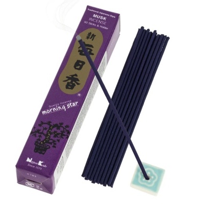 Caixa roxa de incenso japonês musk com varetas escuras e suporte quadrado azul-claro