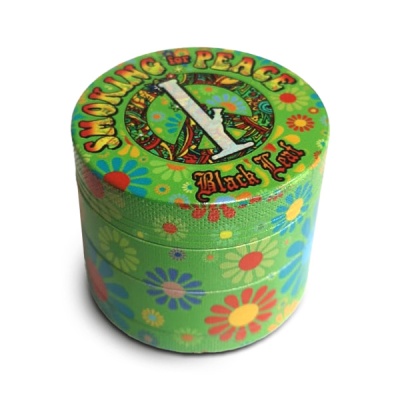 Mini caixa de metal verde com padrão floral colorido e texto no topo