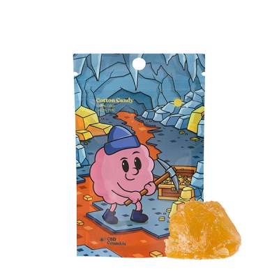 Pacote azul e laranja com personagem cor-de-rosa e pedaço amarelo de CBD Crumble