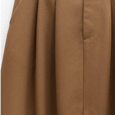 Parte superior de roupa castanha com pregas e passadores para cinto