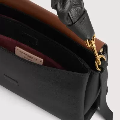 Mala de mão preta em pele com alça trançada e interior borgonha e castanho