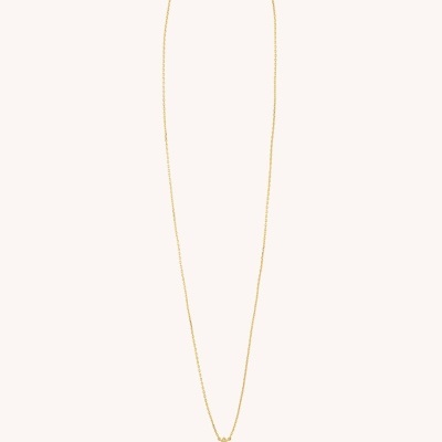 Colar dourado com pendente cruz detalhada sobre fundo bege