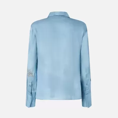 Camisa azul clara de manga comprida vista de costas com bordado prateado na manga