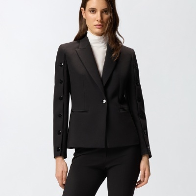 Blazer feminino preto com botões nas mangas e calças pretas, com camisola branca de gola alta