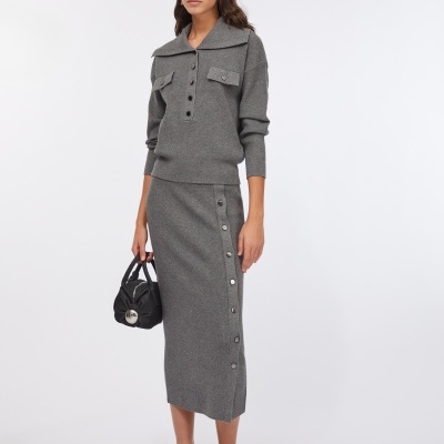 Conjunto feminino cinzento em malha com camisola de gola ampla e saia midi com botões.