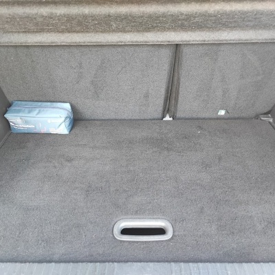 Compartimento de bagageira de carro cinza com caixa azul