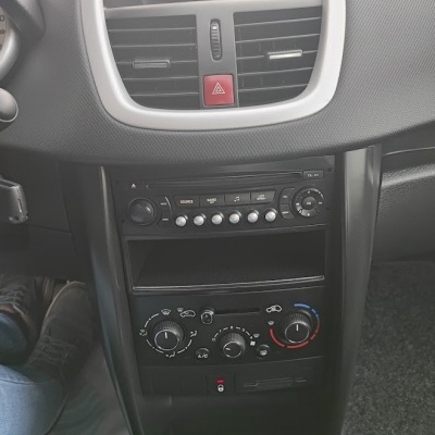 Painel central do tablier do carro com rádio, controlo do ar condicionado e manete de caixa manual