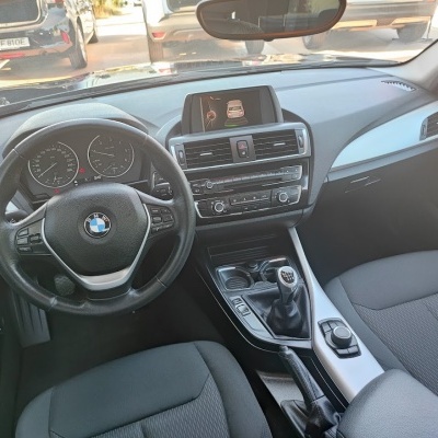 Interior de carro BMW preta com volante em couro e comando manual