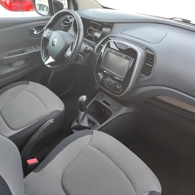 Interior de carro com volante preto, assentos cinza e painel com ecrã digital