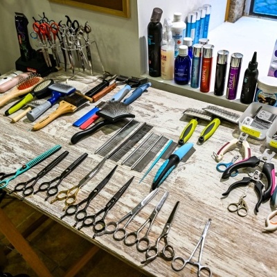 Ferramentas e produtos de cabeleireiro dispostos sobre mesa de madeira