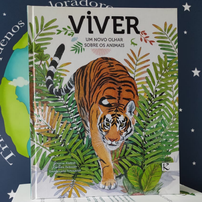 Capa de livro com ilustração de tigre e folhagens com texto VIVER UM NOVO OLHAR SOBRE OS ANIMAIS