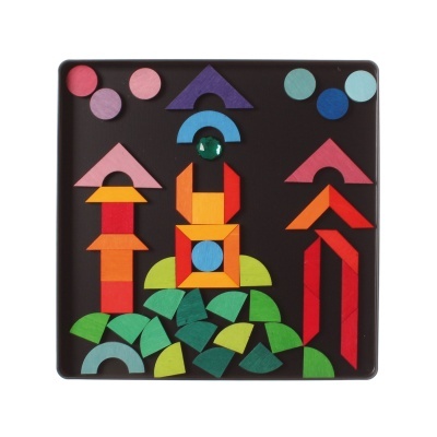 Peças geométricas de madeira coloridas organizadas numa base preta