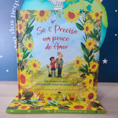 Livro infantil com capa ilustrada de girassóis, título 'Só é Preciso um pouco de Amor' e duas personagens desenhadas