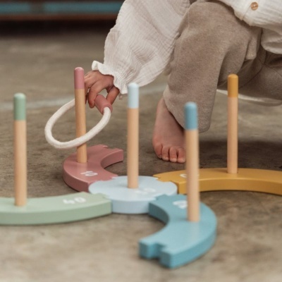 Jogo de argolas de madeira colorida com criança a jogar no chão