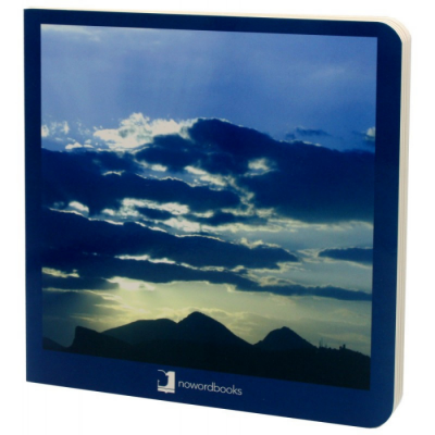 Livro com capa de céu azul, nuvens e montanhas ao pôr do sol