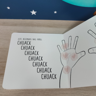 Página de livro infantil com mão desenhada e texto em português.
