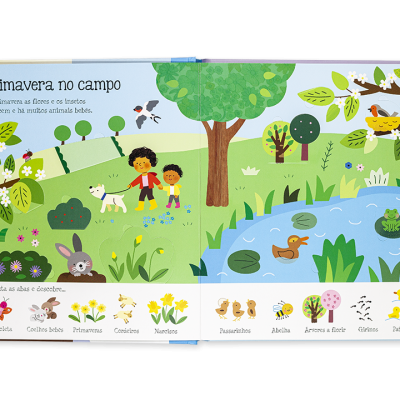 Livro infantil aberto mostrando uma ilustração colorida de primavera no campo com crianças e animais.