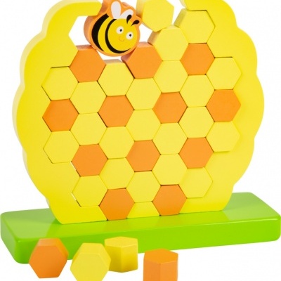 Quebra-cabeça de colmeia amarelo com blocos hexagonais e abelha em base verde