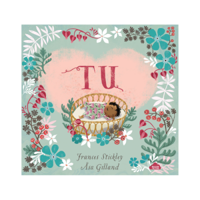 Capa de livro com bebé em cesta e flores coloridas à volta