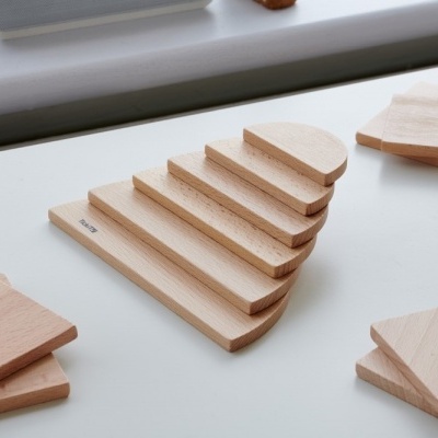 Tábuas de madeira clara de várias formas sobre superfície branca