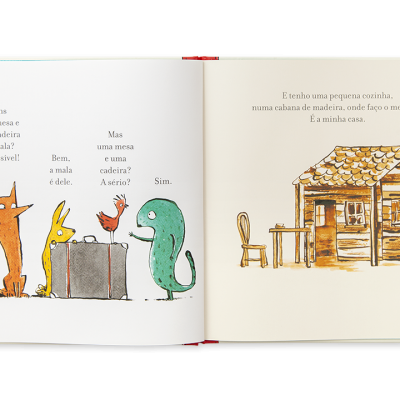 Livro aberto com ilustrações de animais e uma casa pequena de madeira