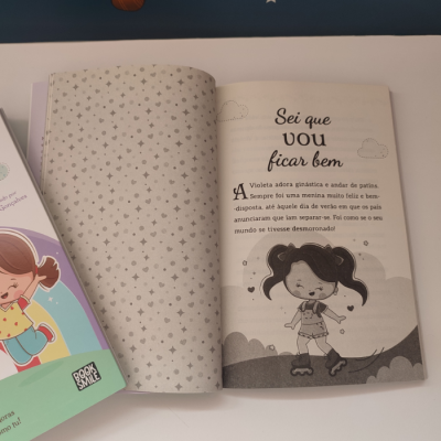 Livro infantil aberto com ilustrações a preto e branco e texto em português.