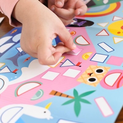 Criança montando um puzzle com animais e formas geométricas coloridas