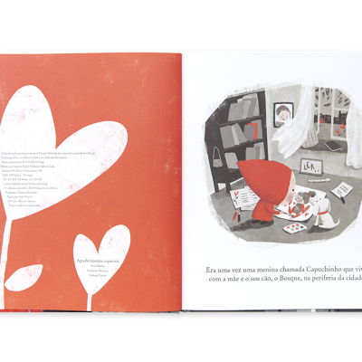 Página de livro infantil com ilustrações de coração e menina com capa vermelha e cão em cenário urbano