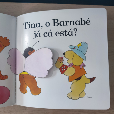 Página de livro infantil com ilustrações de borboleta e cão, texto em português