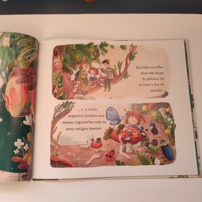 Livro infantil aberto com ilustrações coloridas e texto em português