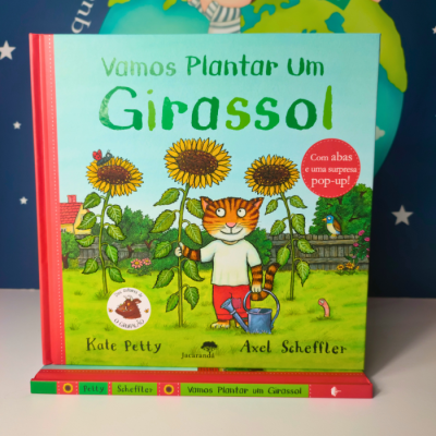 Livro 'Vamos Plantar Um Girassol' com ilustração de gato e girassóis coloridos.
