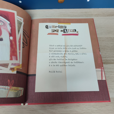 Livro aberto com carta de Natal e ilustrações coloridas