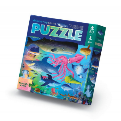 Caixa de quebra-cabeças com imagens coloridas de tubarões e peixes e indicação de 60 peças para maiores de 4 anos.